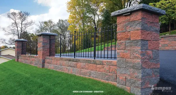 Versa-Lok Standard columns and retaining wall in Saratoga color blend with iron fencing